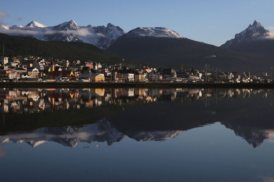 USHUAIA, ARGENTINA - NOVEMBER 05:  Ushuaia is reflected near the main docks on November 5, 2017 in Ushuaia, Argentina. Ushuaia is situated along the southern edge of Tierra del Fuego, in the Patagonia region, and is commonly known as the 'southernmost city in the world'. The city's main fresh water supply comes from the retreating Martial Glacier, which may be at risk of disappearing. In a 2015 report, warming temperatures led to the loss of 20 percent of the mass and surface of glaciers in Argentina over the previous 50 years, according to Argentina's Institute of Nivology, Glaciology and Environmental Sciences (IANIGLIA). Ushuaia and surrounding Tierra del Fuego face other environmental challenges including a population boom leading to housing challenges following an incentivized program attracting workers from around Argentina. Population in the region increased 11-fold between 1970 and 2015 to around 150,000. An influx of cruise ship tourists and crew, many on their way to Antarctica, has also led to increased waste and pollution in the area sometimes referred to as 'the end of the world'.  (Photo by Mario Tama/Getty Images)