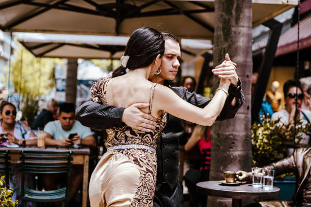 Montevideo, Uruguay - December 22, 2022: Tango dancers performing for tourists outside of a restaurant on a street corner in the old town of Montevideo, capital of Uruguay