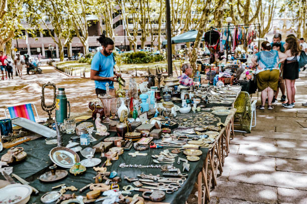 Montevideo, Uruguay - December 22, 2022: Visitors viewing the eclectic offerings on display at a flea market in the old town of Montevideo, capital of Uruguay