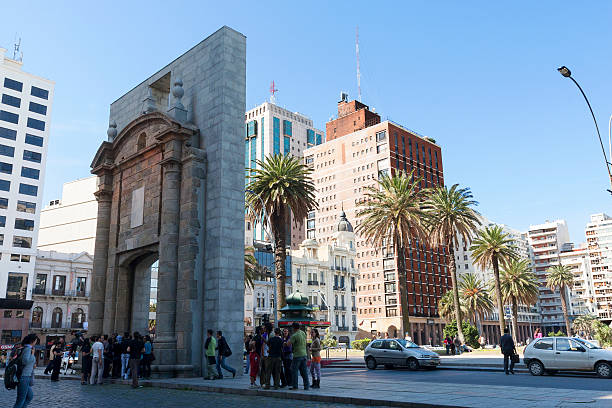 Montevideo, Uruguay - October 6, 2011: A group of young men and women gathering at Puerta de la ciudadela, in front of Plaza Independencia in the Ciudad Vieja Area of Montevideo